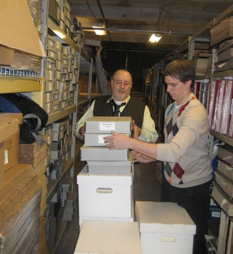 Charlie Tonetti and Christian Kronenwetter (L to R) carefully move boxes containing the Association for Preservation Technology International (APT) Archives into their new home at the Philadelphia Athenaeum. | Photo courtesy of Association for Preservation Technology International (APT)