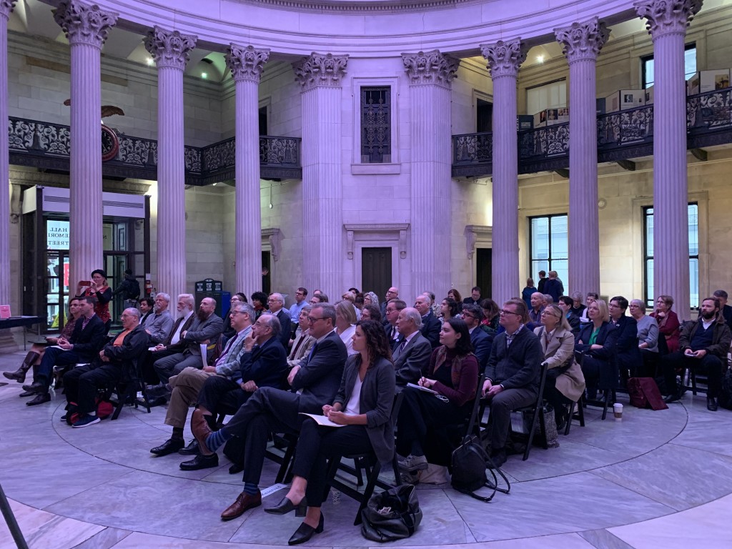 A crowd gathers to celebrate George McAneny’s sesquicentennial year at the Archive Project’s October 17th event, “Honoring the Spirits of McAneny,” hosted at Federal Hall National Memorial. | Courtesy Josie Naron  